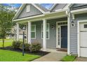 Inviting front entrance with elegant columns, fresh landscaping, and a stylish front door at 504 Foxbank Plantation Blvd, Moncks Corner, SC 29461