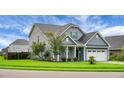 View of home with a well-kept lawn and landscaping, plus a 2 car garage at 504 Foxbank Plantation Blvd, Moncks Corner, SC 29461