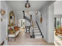 Elegant foyer with staircase, hardwood floors, decorative mirror, and sophisticated decor at 70 King St, Charleston, SC 29401