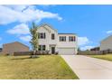 Inviting two-story home with a well-maintained lawn, a two-car garage, and a classic white facade at 715 Mcroy St, Moncks Corner, SC 29461