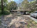 Modest single story house with ramp and small front porch, driveway, and mature landscaping at 719 Wantoot Blvd, Charleston, SC 29407