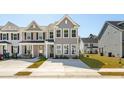 A new construction gray home is set back from the street with a long driveway at 825 Alma Square Dr, Moncks Corner, SC 29461