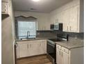 Cozy kitchen with stainless steel appliances and tile backsplash at 8392 Herbert Smalls Rd, Edisto Island, SC 29438