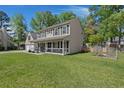 Charming home with a covered front porch, a spacious lawn, and a garden area at 8524 Belford Ct, North Charleston, SC 29420