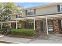 Attractive townhome with brick and siding exterior, covered porch, and well-maintained front yard at 880 Simpkins St # 2, Charleston, SC 29412