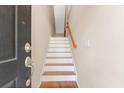 View of an entry staircase featuring hardwood treads, white risers, and a wooden handrail at 9226 Southern Oak Ln, Ladson, SC 29456
