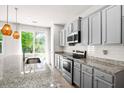 Modern kitchen with granite countertops, stainless steel appliances, and tile backsplash at 9428 Sweep Dr, Summerville, SC 29485
