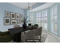 Formal dining area with large windows and stylish decor, virtually staged at 1047 Tyron Cir, Charleston, SC 29414