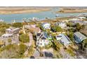 Stunning aerial view of the home with solar panels, lush landscaping, and picturesque waterway at 109 Carolina Blvd, Isle of Palms, SC 29451