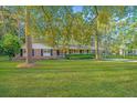 Traditional brick home featuring a spacious yard, carport, and mature trees at 112 Furlong Rd, Summerville, SC 29483