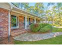 Charming covered porch with brick walkway and manicured landscaping at 112 Furlong Rd, Summerville, SC 29483