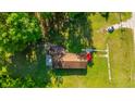 Aerial shot of home, showcasing its roof, lawn, and surrounding trees at 11341 Cottageville Hwy, Cottageville, SC 29435