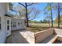 Private backyard featuring a deck with built-in seating overlooking the golf course at 12 Trail Hollow Ct, Charleston, SC 29414
