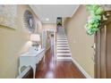 Hallway with hardwood floors, staircase, decorative lighting, and an inviting atmosphere at 1215 Dingle Rd, Mount Pleasant, SC 29466