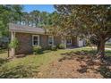 Lovely brick home with a lush front yard and mature tree, creating shade at 122 William St, Summerville, SC 29486