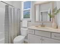 Bathroom with a white vanity, mirror, and shower/tub combination at 123 Brown Swiss Cir, Summerville, SC 29483