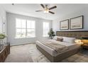 Cozy primary bedroom featuring large windows, carpeted floors, and a ceiling fan at 125 O'Malley Dr, Summerville, SC 29483