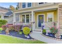 Close-up of the home's inviting front porch with colorful plants and decorations at 132 Daniels Ridge Dr, Summerville, SC 29485
