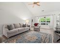 Bright living room with vaulted ceiling, large windows, and modern decor accents at 1362 Palm Cove Dr, Charleston, SC 29492