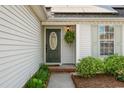 Inviting front entrance with green door, stone pathway, beautiful plants and classic fixtures at 1379 Downsberry Dr, Mount Pleasant, SC 29466