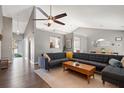 Spacious living room with vaulted ceiling, modern fan, hardwood floors and large sectional couch at 1379 Downsberry Dr, Mount Pleasant, SC 29466