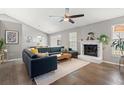 Open concept living room with fire place, hardwood floors and sectional couch at 1379 Downsberry Dr, Mount Pleasant, SC 29466