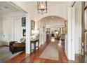 Elegant hallway with wood floors and arched doorways, leading to the living areas at 158 Mary Ellen Dr, Charleston, SC 29403