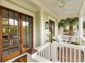 Inviting porch with light green trim, white railings, and french doors at 158 Mary Ellen Dr, Charleston, SC 29403