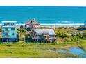 Beautiful coastal home with ample decking and ocean views, situated next to the marsh and other beachfront homes at 1604 E Ashley Ave, Folly Beach, SC 29439