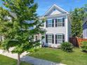 Well-maintained two story home featuring classic design elements, a tidy lawn, and mature shade trees at 1673 Emmets Rd, Johns Island, SC 29455