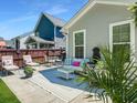 Stylish outdoor patio area with comfortable seating, decorative pillows, and lush landscaping at 1673 Emmets Rd, Johns Island, SC 29455