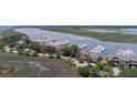 An aerial photograph captures waterfront condos and the marina with boats docked along the harbor at 1880 Andell Bluff Blvd # Slip E 9, Johns Island, SC 29455