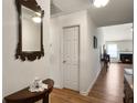 Inviting entryway with wood-look floors, leading to the living room with a fireplace at 1921 Old Parsonage Rd, Charleston, SC 29414