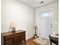 Bright entryway with hardwood floors, white door and trim, and stylish furnishings at 1921 Old Parsonage Rd, Charleston, SC 29414