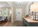 Warm and inviting foyer with console table, stylish decor, wood floors and view of the front door at 23 Hunters Forest Dr, Charleston, SC 29414
