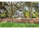 Charming home with beautiful landscaping, mature trees, and lush green lawn at 2455 The Bent Twig, Seabrook Island, SC 29455