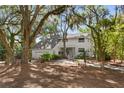 Beautiful home with lush landscaping, mature trees, and a charming pergola entrance at 2455 The Bent Twig, Seabrook Island, SC 29455
