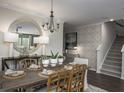 Beautiful dining room featuring modern chandelier, wallpaper accent wall, and staircase at 263 Camellia Bloom Dr, Moncks Corner, SC 29461