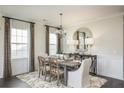 Elegant dining room featuring a stylish chandelier, large mirror, and wood flooring at 263 Camellia Bloom Dr, Moncks Corner, SC 29461