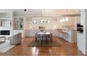 Open-concept dining room boasts hardwood floors, statement lighting, and access to kitchen at 3007 Cameron Blvd, Isle of Palms, SC 29451
