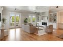 Bright living room features hardwood floors, a fireplace, built-in shelving, and French doors at 3007 Cameron Blvd, Isle of Palms, SC 29451