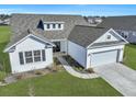 Charming single-story home features a manicured lawn, two-car garage, and classic white siding at 308 Cypress Branch Rd, Huger, SC 29450