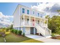 Inviting two-story home with a charming front porch, perfect for relaxing outdoors at 3107 S Shore Dr, Charleston, SC 29407