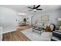 Open-concept living room featuring hardwood floors, a ceiling fan, and natural light at 3227 Stonehaven Dr, North Charleston, SC 29420