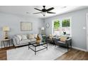 Cozy living room with large windows, hardwood floors, and stylish furnishings at 3227 Stonehaven Dr, North Charleston, SC 29420