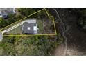 Aerial view of a property with defined boundaries, including mature landscaping, a driveway, and a two-story home at 3547 Holmgren St, Mount Pleasant, SC 29466