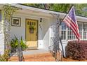 Close-up of the front porch featuring a decorative yellow door and charming details at 405 Cross St, Charleston, SC 29407