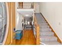 Inviting foyer with hardwood floors, staircase, and a glimpse into the living area, offering a warm welcome at 406 King Charles Cir, Summerville, SC 29485