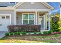 Charming front porch with seating area and manicured landscaping at 411 Freeland Way, Moncks Corner, SC 29461