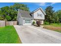 Inviting exterior with grey siding, neat landscaping, and a concrete driveway leading to the charming two-story home at 422 Temple Rd, Ladson, SC 29456